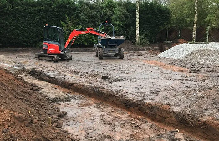 Professional excavation services in Manchester showing excavator at work on construction site